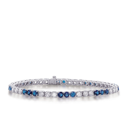 This Bracelet is available in 14K White Gold. There are a total of 54 stones. There are Round with a total carat weight of 3 set in a  setting.There are Sapphire stones with a total carat weight of 4.38 set in a .
