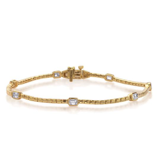 This Bracelet is available in 14K Yellow Gold. There are a total of 7 stones. There are Emerald Cut with a total carat weight of 0.99 set in a Bezel Set setting.