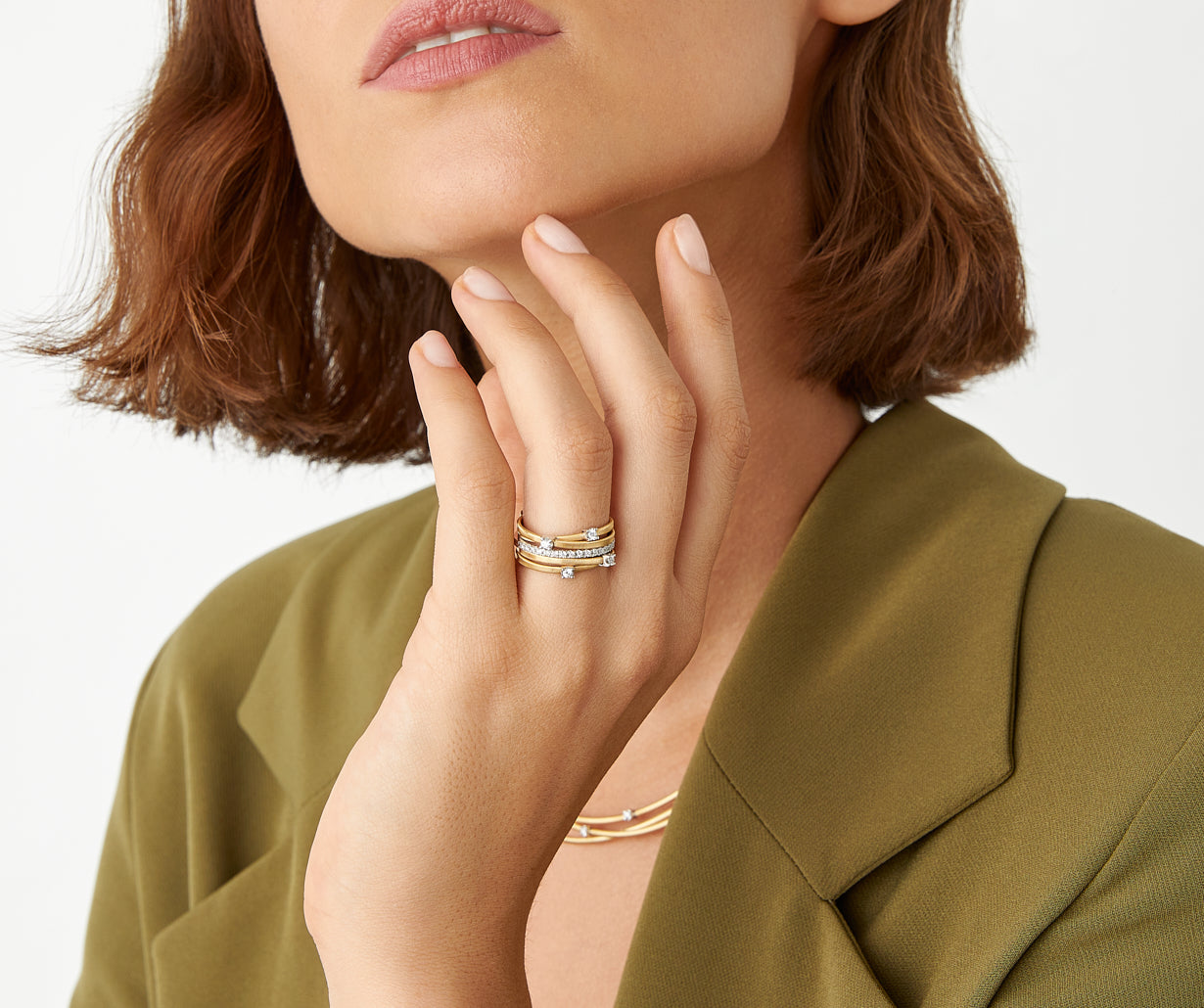 Five-band yellow gold ring with prong-set diamonds and a diamond-studded plaque