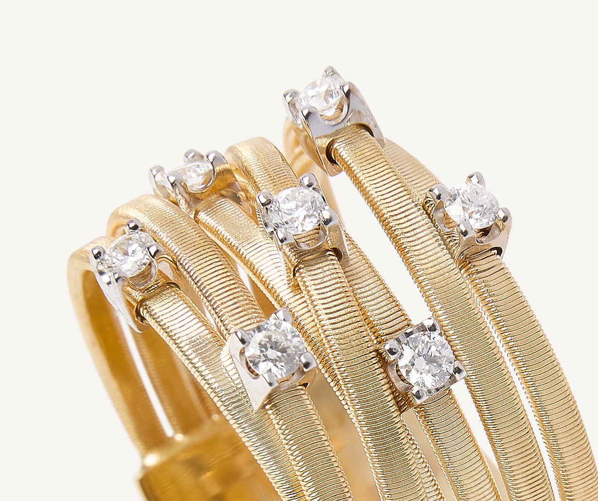 Seven-band yellow gold ring with prong-set diamonds