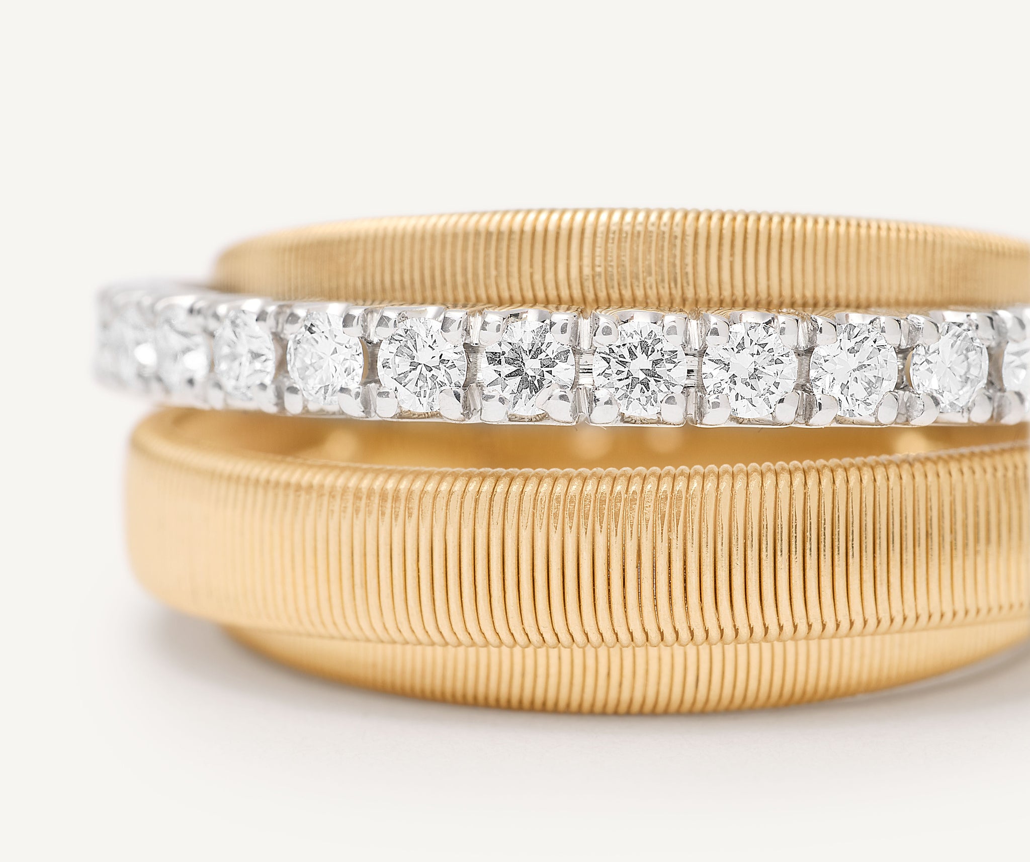 18kt yellow gold 4-strand coil ring with diamond pav band
