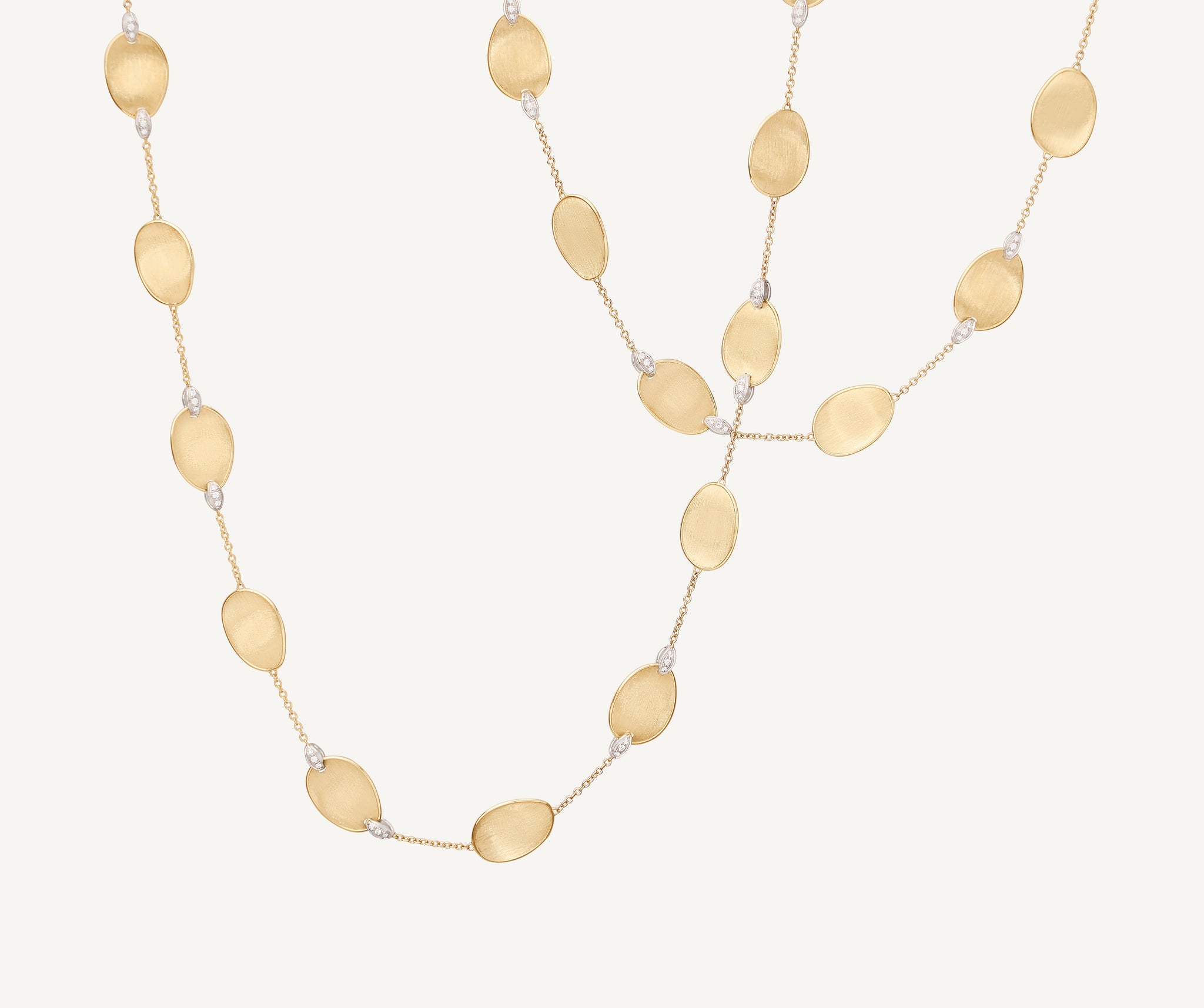 Long necklace with 18kt yellow gold leaves and diamond accents