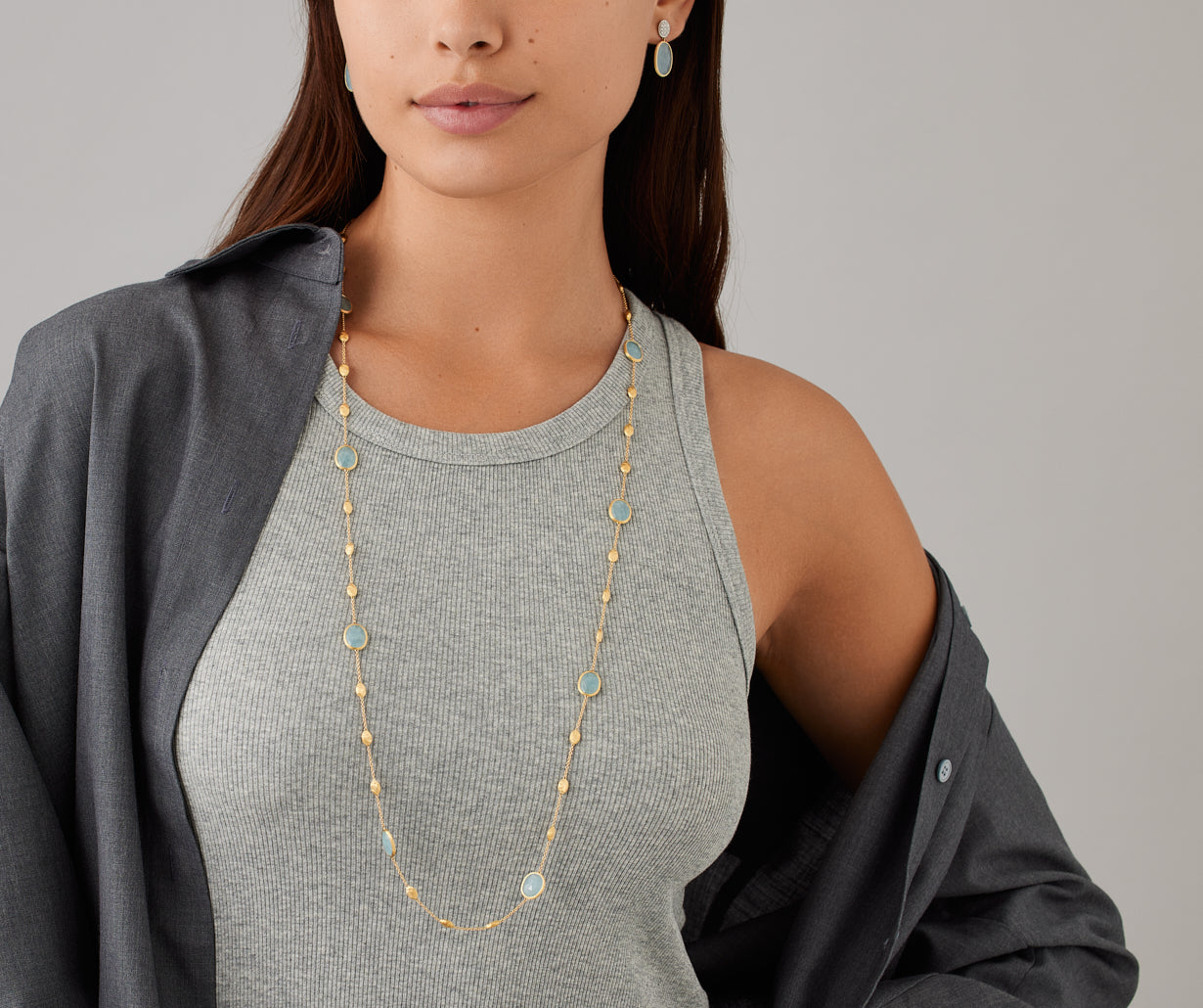18kt yellow gold long necklace with small oval elements, aquamarines, and diamonds