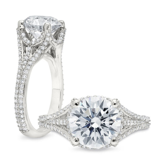 Peter Storm A striking piece, it features a large round center stone that looks as if it is floating in the basket of diamond supports surrounding the center WSM376_4DiaW  WSM376_4DiaW