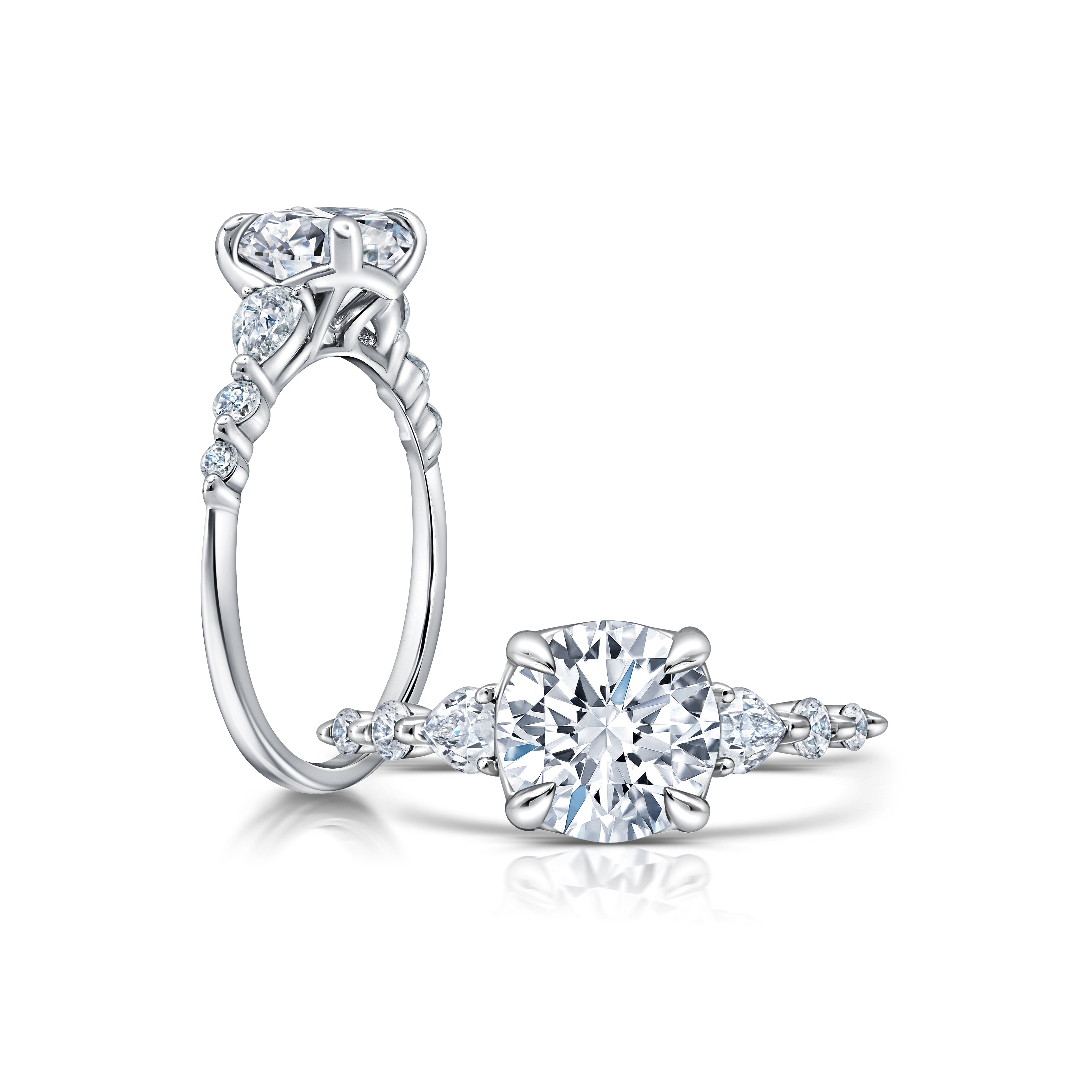 A classic twist on a three stone ring, this ring features two pear shape diamonds sitting on either side of your chosen center WSM675_4DIAY