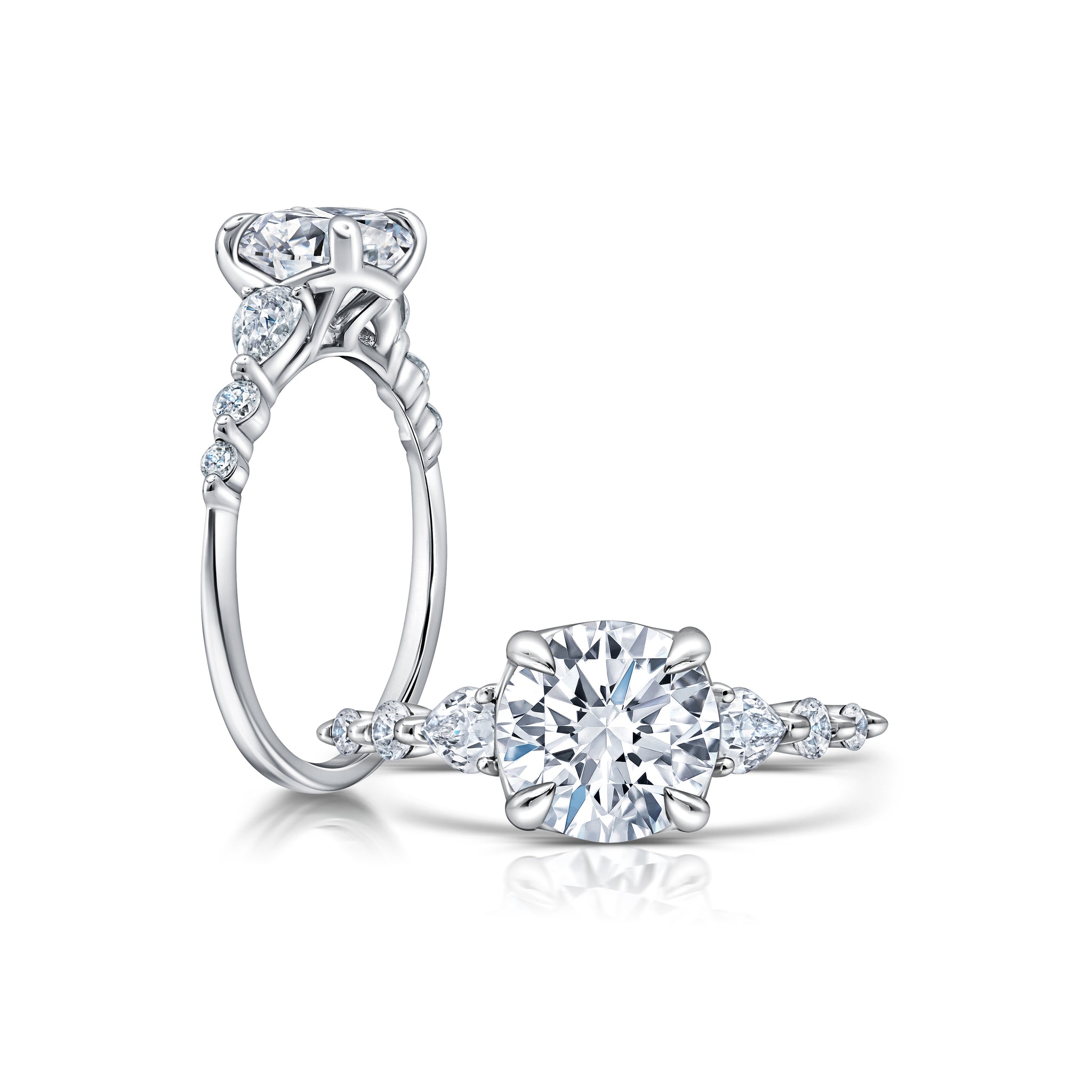 A classic twist on a three stone ring, this ring features two pear shape diamonds sitting on either side of your chosen center WSM675_4DIAY