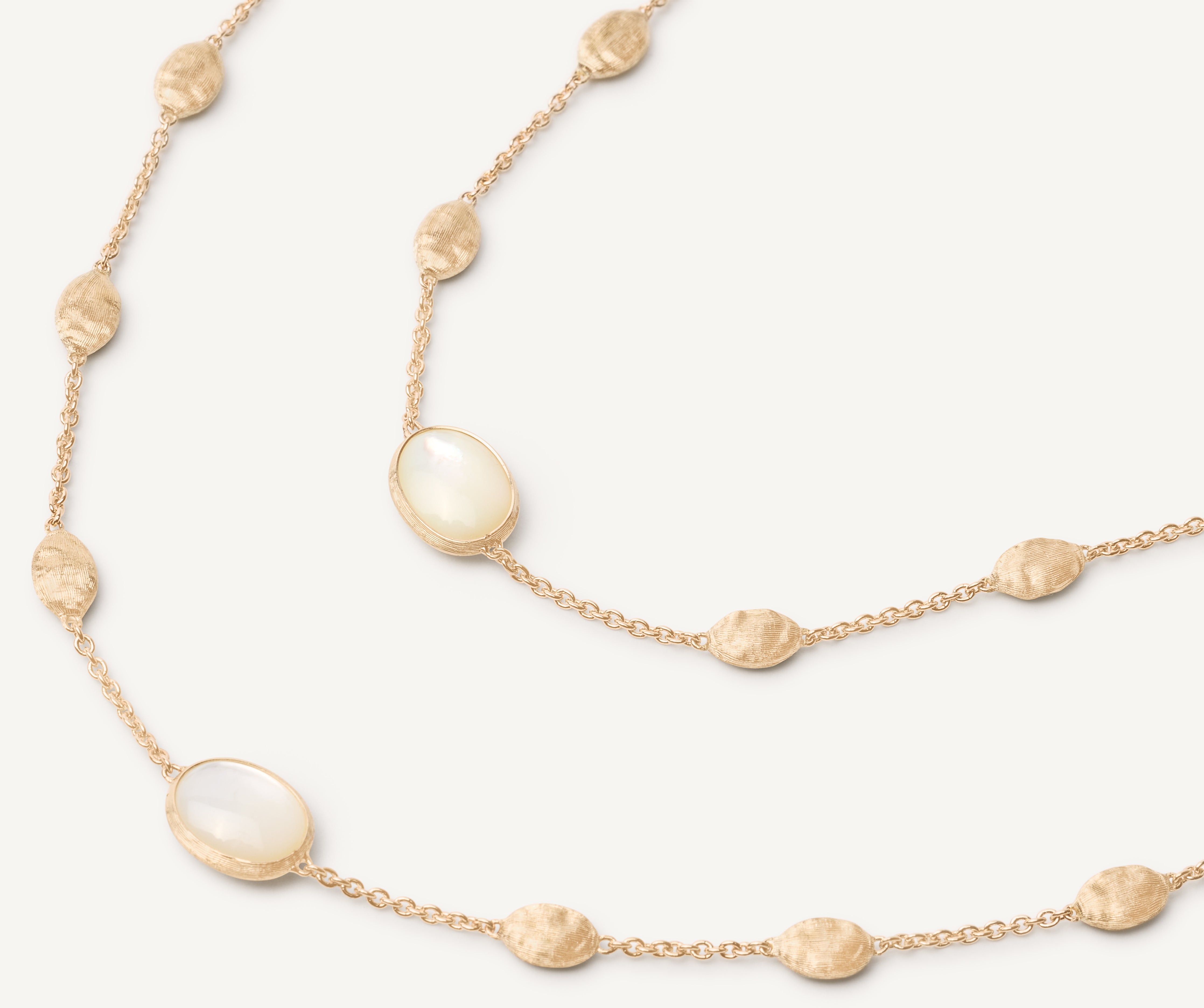 18kt yellow gold long necklace with small ovals, mother-of-pearl, and diamonds