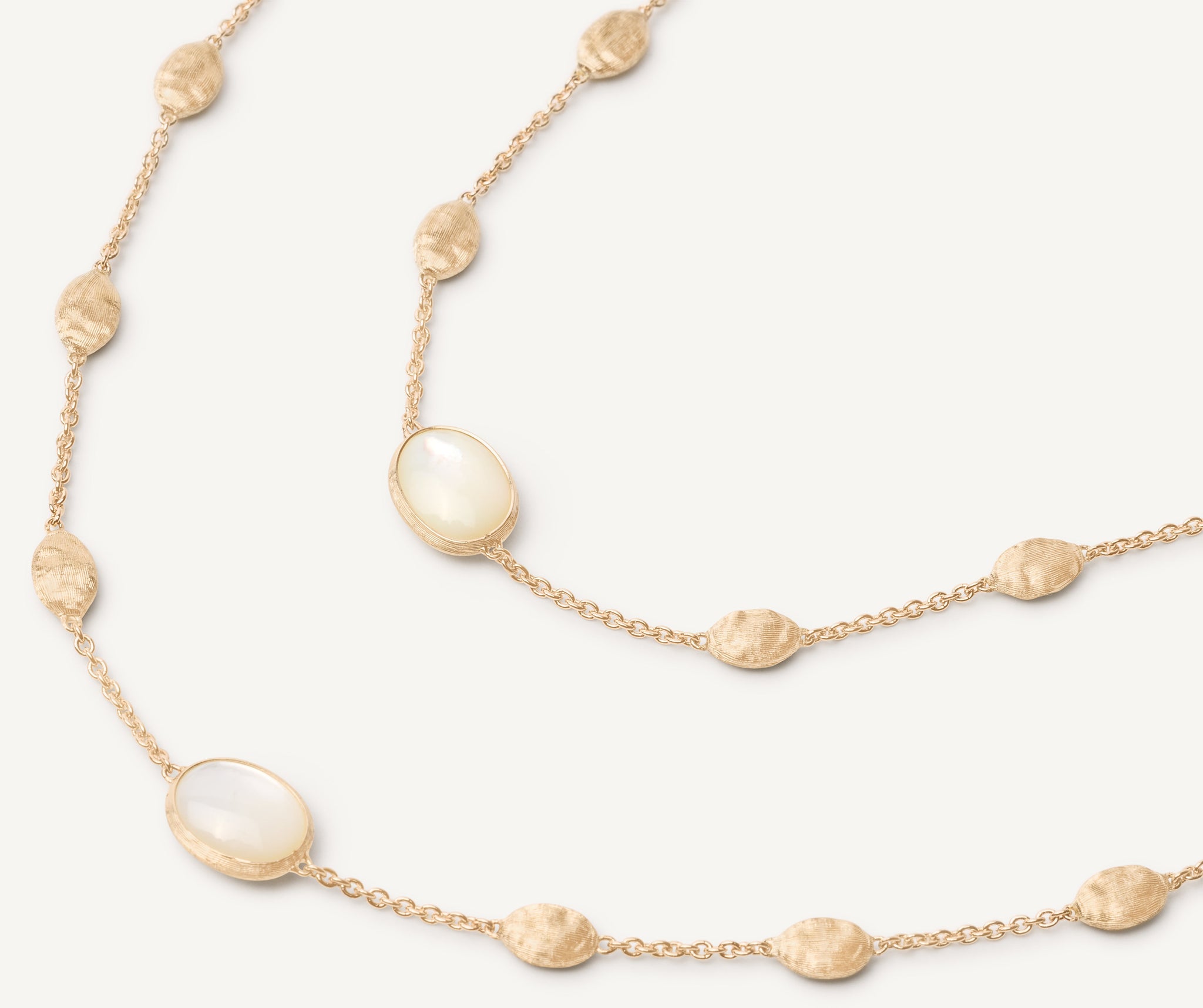 18kt yellow gold long necklace with small ovals, mother-of-pearl, and diamonds