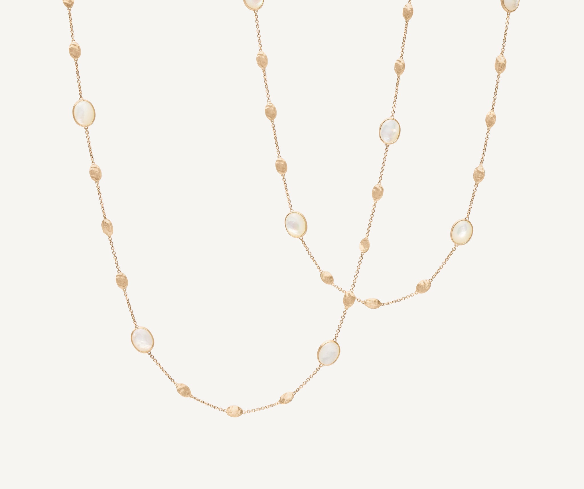 18kt yellow gold long necklace with small ovals, mother-of-pearl, and diamonds