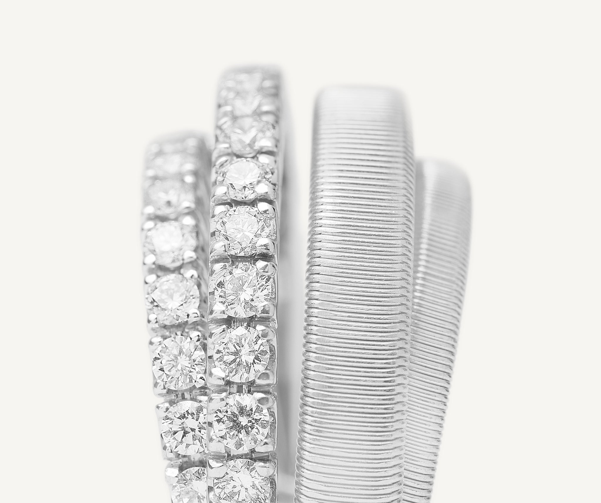 18kt white gold 4-strand coil ring with diamond 2 pav bands