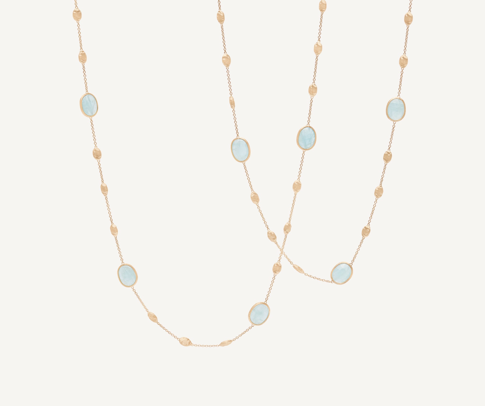 18kt yellow gold long necklace with small oval elements, aquamarines, and diamonds